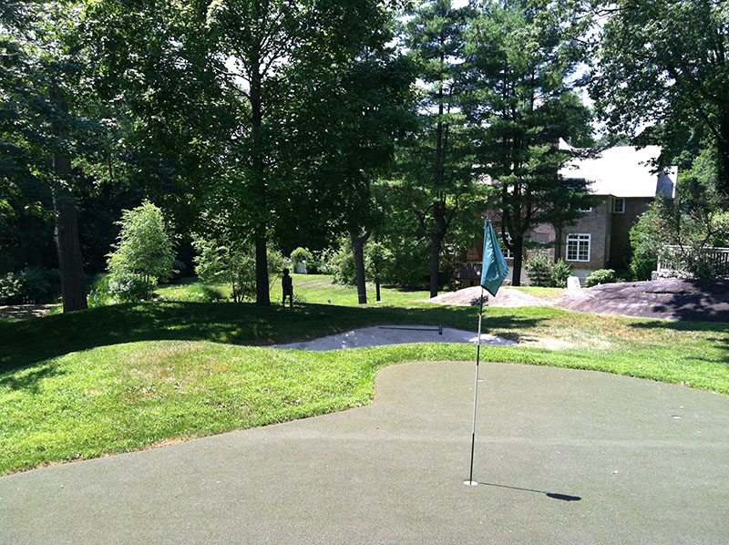 putting green with house in background