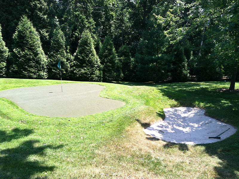 putting green and sand trap in backyard