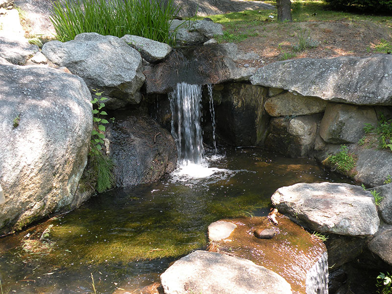 Miniature waterfall near pool
