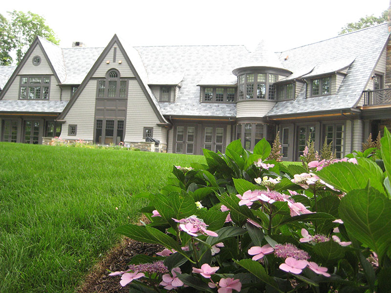 pink flowers with mansion in background