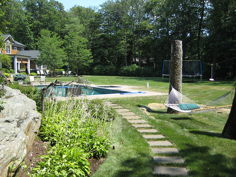 large backyard with hammock and pool