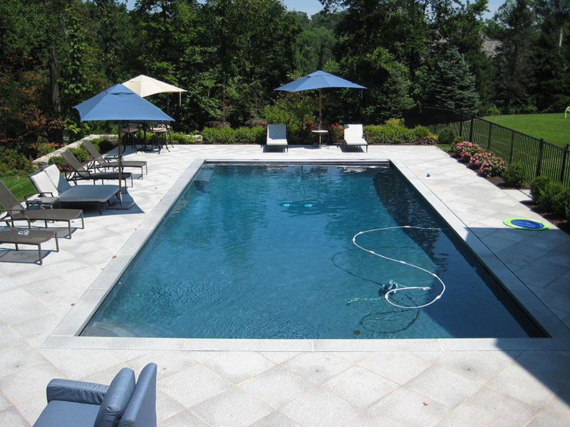 wide view of pool with gray patio width