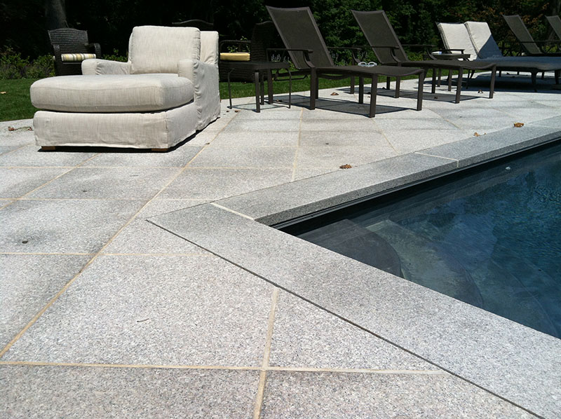 gray stone patio around pool